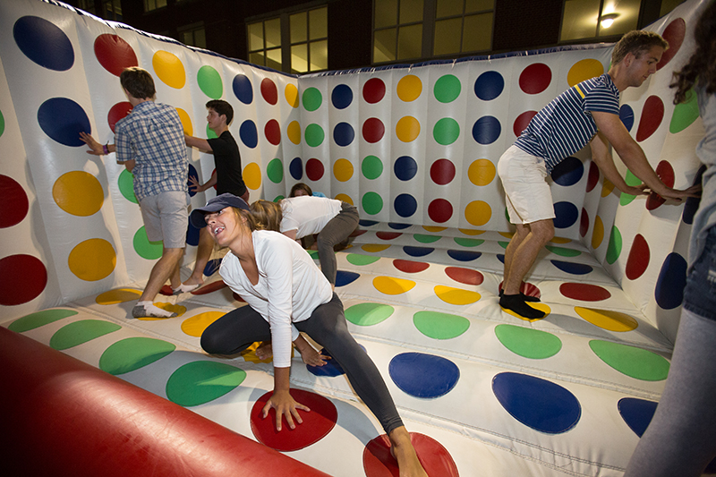 Students play 3-d twister on an inflatable